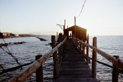 Pier over sea against clear sky