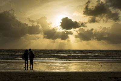 Rear view of man standing on beach