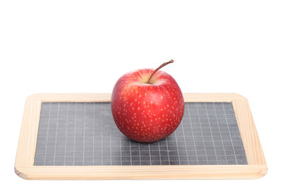 Close-up of red apple against white background