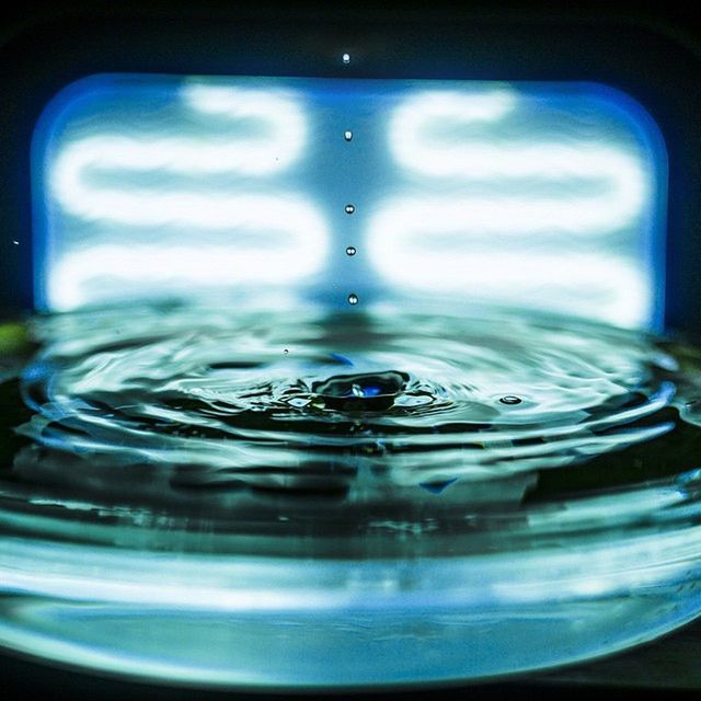 water, drop, transparent, refreshment, close-up, glass - material, bubble, indoors, drink, blue, freshness, drinking glass, glass, reflection, wet, focus on foreground, purity, splashing, liquid, motion