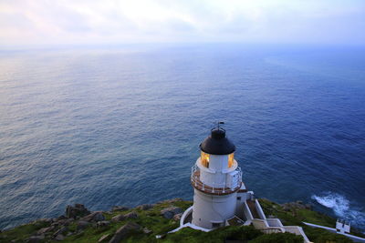 High angle view of lighthouse amidst sea against sky