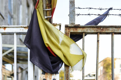 Close-up of flags hanging on railing