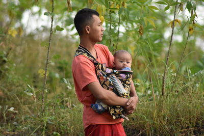 Father and baby girl with plants