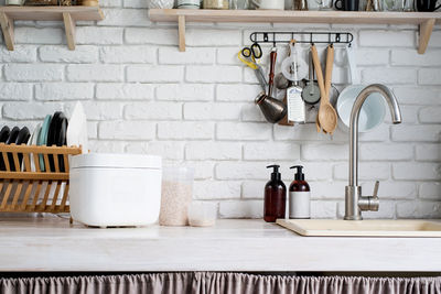 Electric smart rice cooker on wooden counter-top in the kitchen with brown rice