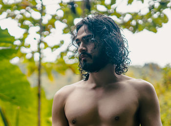 Portrait of shirtless man looking away