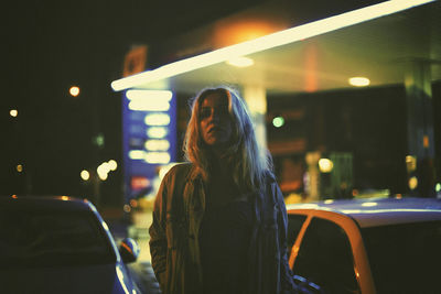 Portrait of a stylish caucasian woman in a gas station.