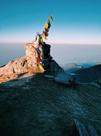 Praying flags on mountain against sky