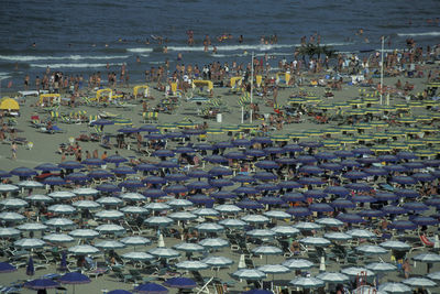 High angle view of crowd on beach against buildings in city