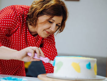 Side view of girl eating food at home