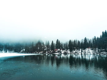 Scenic view of lake against sky during winter