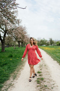 Full length of woman on grass against sky