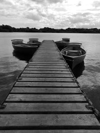 Pier over lake against sky