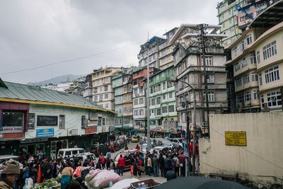 People on street amidst buildings in city