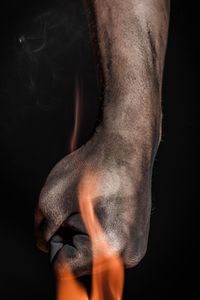 Close-up of man against black background