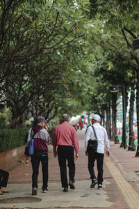 Rear view of people walking on street