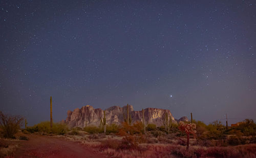 Scenic view of land against sky at night