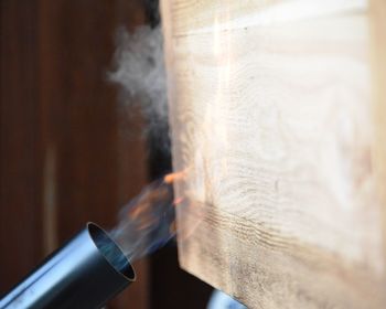 Close-up of flame thrower burning wood