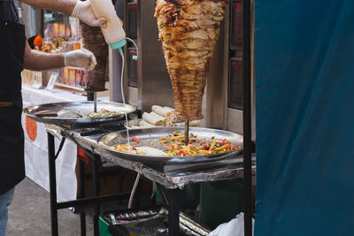 Midsection of man preparing food on table