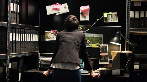 Rear view of man working at home