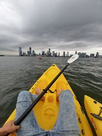 Yellow boat in sea against sky