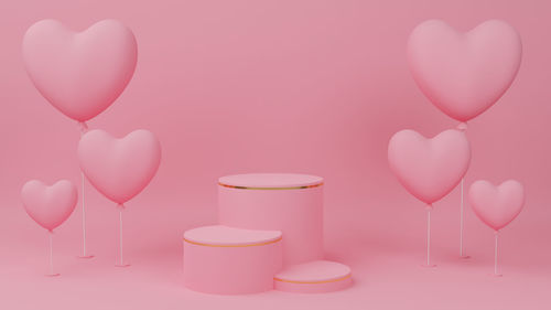 Close-up of pink balloons against colored background