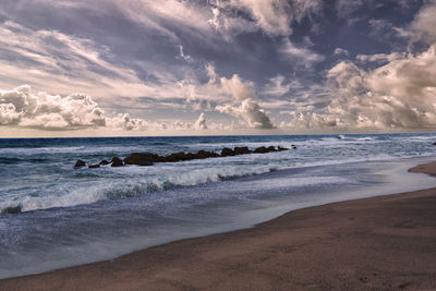 Scenic view of beach against sky