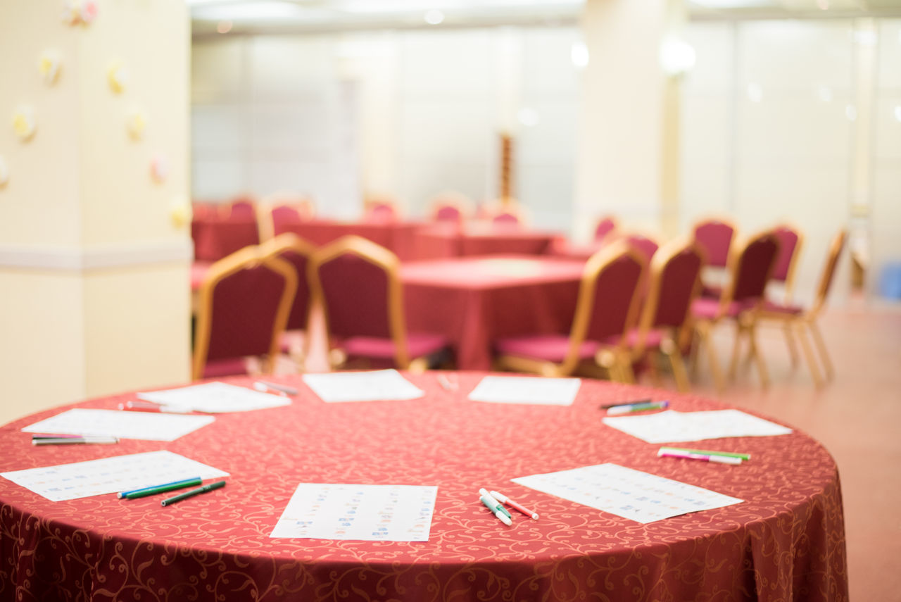 CLOSE-UP OF EMPTY CHAIRS AND TABLES IN ROW