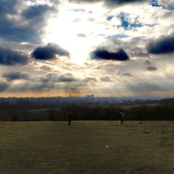 Scenic view of field against sky during sunset