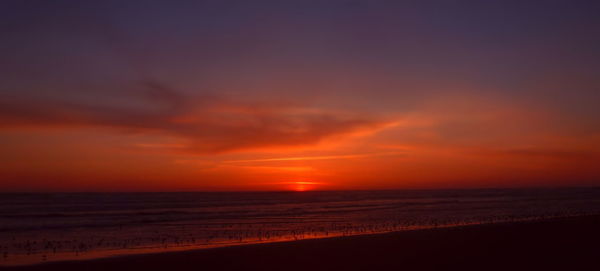 Scenic view of sea against sky at sunset