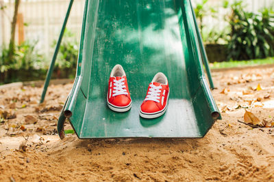 Close-up of shoes on swing