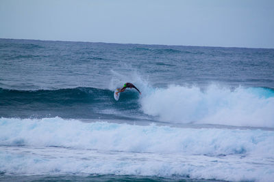 People surfing in sea