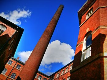 Low angle view of building against cloudy sky