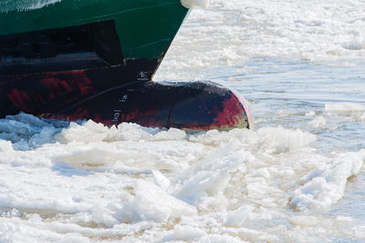 Frozen boat in sea during winter