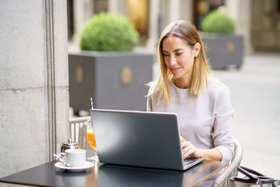 Young woman using laptop at office