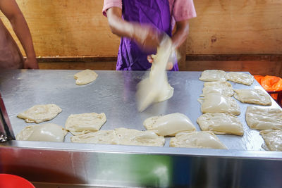 Midsection of man preparing food