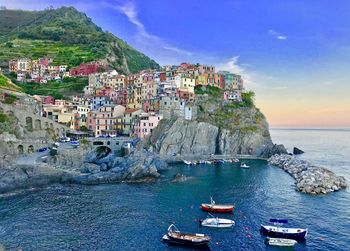 Scenic view of sea by buildings against sky