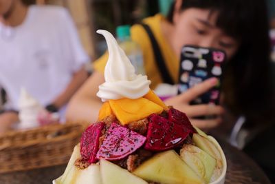 Woman photographing food on table