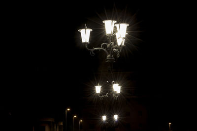 Low angle view of illuminated lights at night