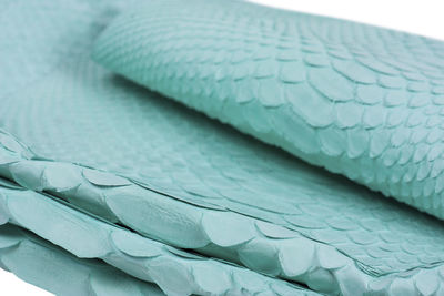 Close-up of blue stack on bed
