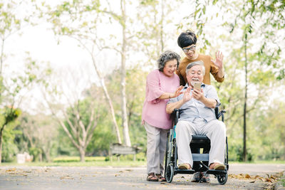 Cheerful family talking on video call outdoors