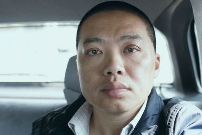 Portrait of man sitting in car