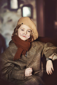 Portrait of smiling young woman wearing hat