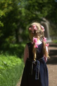 Rear view of girl standing on footpath