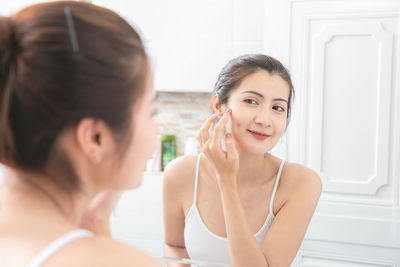 Portrait of beautiful young woman in bathroom