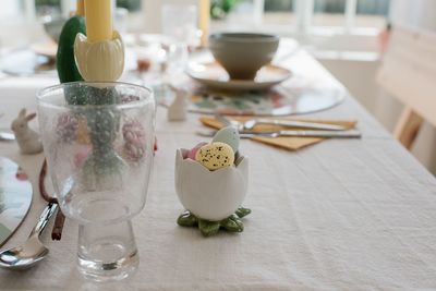 Chocolate easter eggs in an egg cup on a dinner table at home