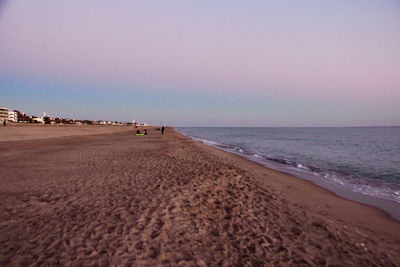 Scenic view of beach against sky during sunset