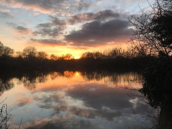 Scenic view of lake against sky during sunset