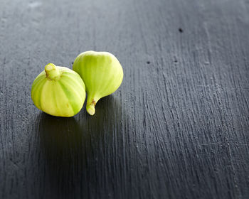 High angle view of unripe figs on table