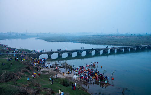 High angle view of people on bridge over river in city
