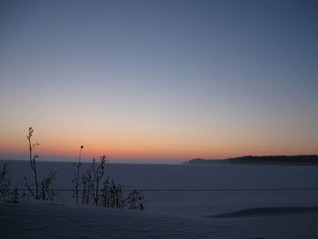 Scenic view of sea against clear sky during sunset